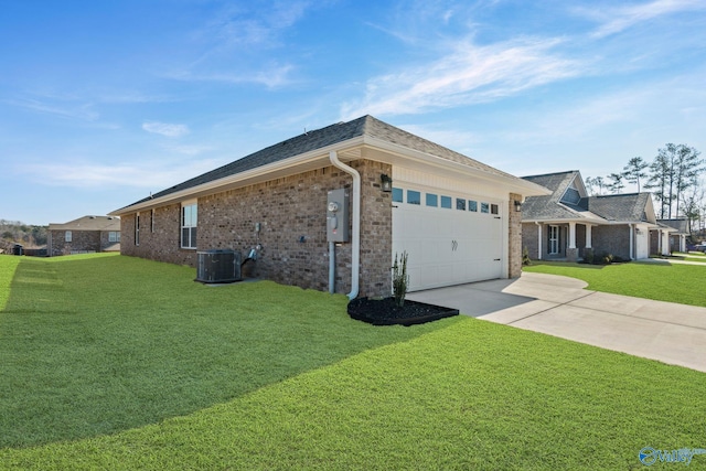 view of side of property with concrete driveway, brick siding, a lawn, and an attached garage