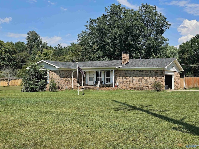 ranch-style home with a garage and a front lawn