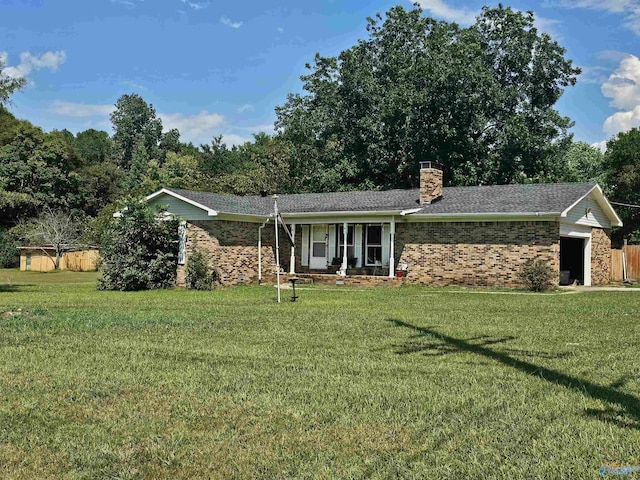 ranch-style home featuring a garage, a front yard, and covered porch