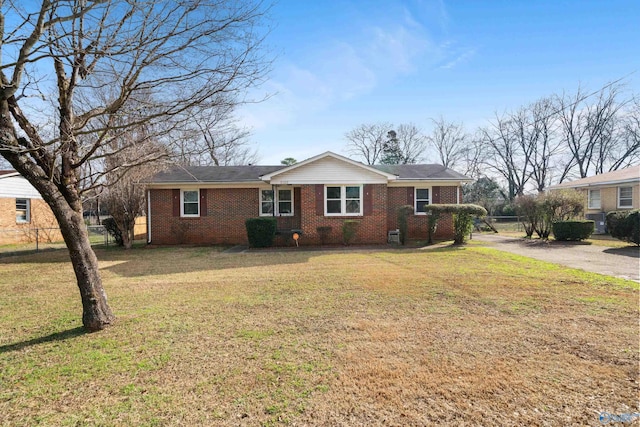 ranch-style home featuring a front yard