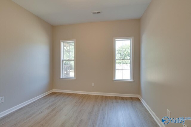 unfurnished bedroom featuring light hardwood / wood-style floors and a closet