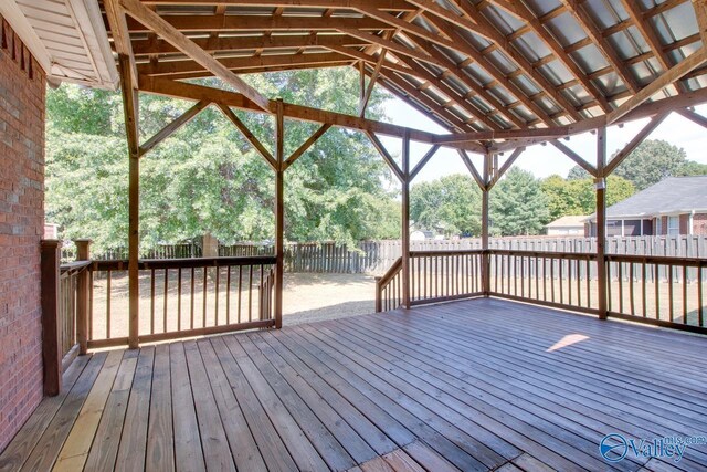 back of property with a wooden deck and a lawn