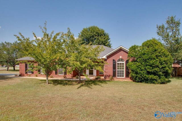 view of front of home with a garage and a front lawn