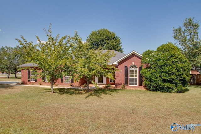 view of front of home with brick siding and a front yard