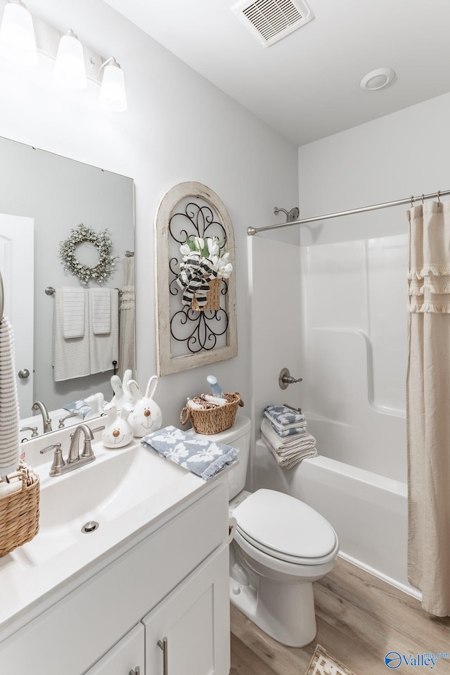 full bathroom featuring toilet, vanity, shower / tub combo with curtain, and wood-type flooring