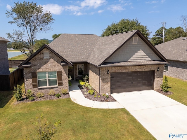 view of front of house with a garage and a front lawn