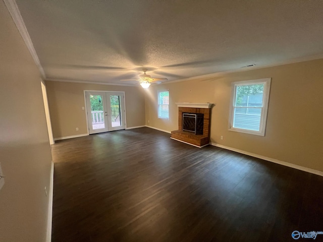 113 Suffolk Dr, Madison, AL 35757 - unfurnished living room featuring crown molding, a ceiling fan, dark wood-type flooring, a brick fireplace, and baseboards