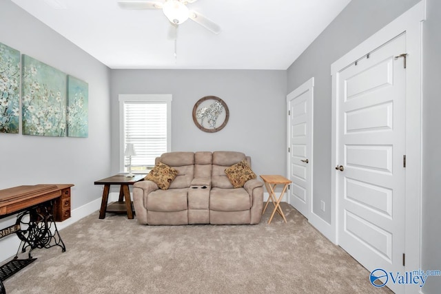 carpeted living room with ceiling fan