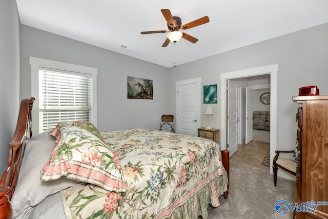 bedroom with light colored carpet and ceiling fan