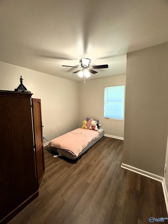 bedroom with dark hardwood / wood-style flooring and ceiling fan