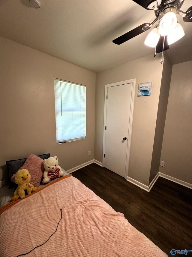 unfurnished bedroom featuring ceiling fan and dark hardwood / wood-style floors