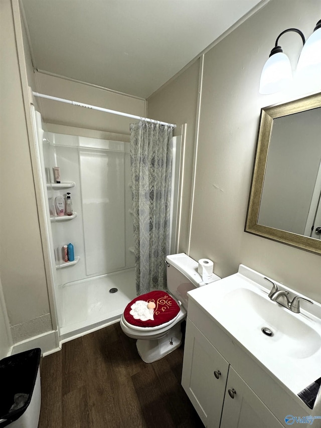 bathroom with wood-type flooring, toilet, vanity, and a shower with shower curtain