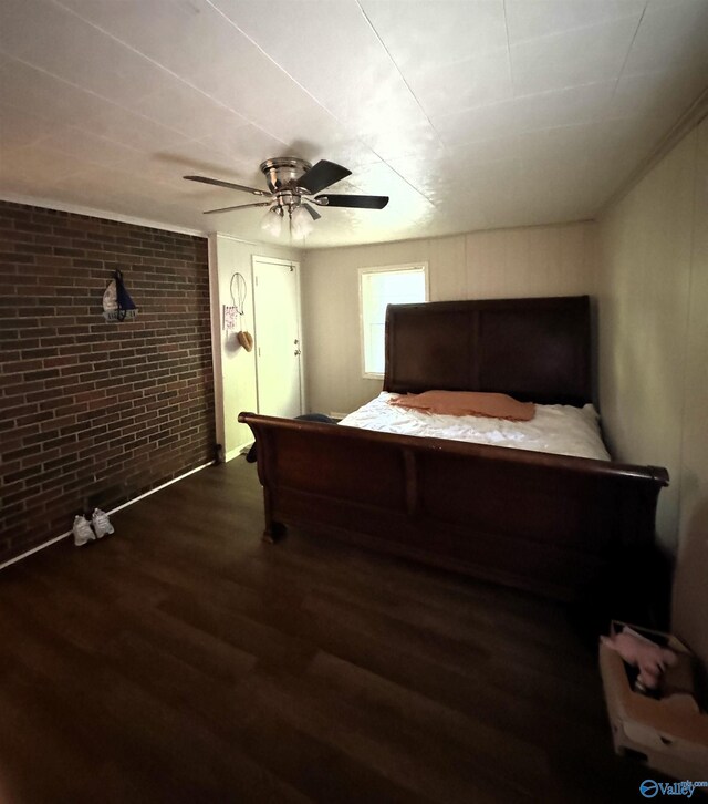 bedroom with brick wall, ceiling fan, and hardwood / wood-style floors