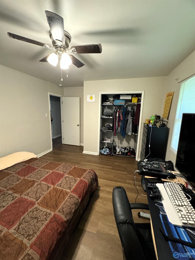 bedroom with a closet, hardwood / wood-style flooring, and ceiling fan