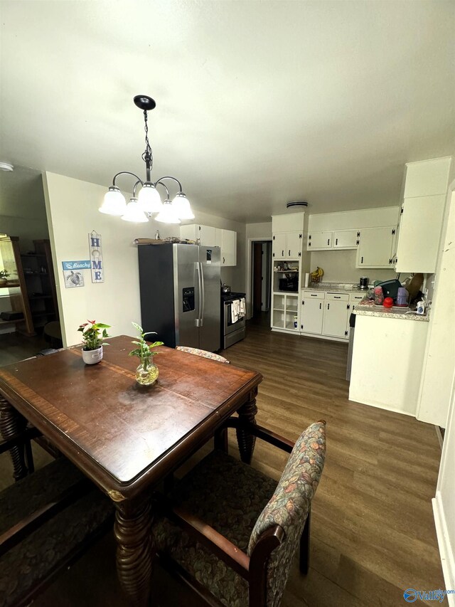 dining room featuring dark hardwood / wood-style flooring and an inviting chandelier