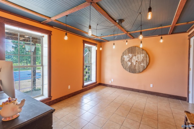 empty room featuring tile patterned floors and a wealth of natural light