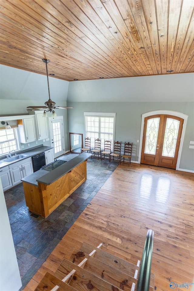 kitchen featuring sink, dishwasher, white cabinets, dark hardwood / wood-style flooring, and french doors