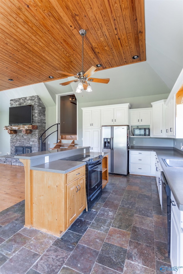 kitchen with white cabinetry, sink, a center island, black appliances, and wooden ceiling