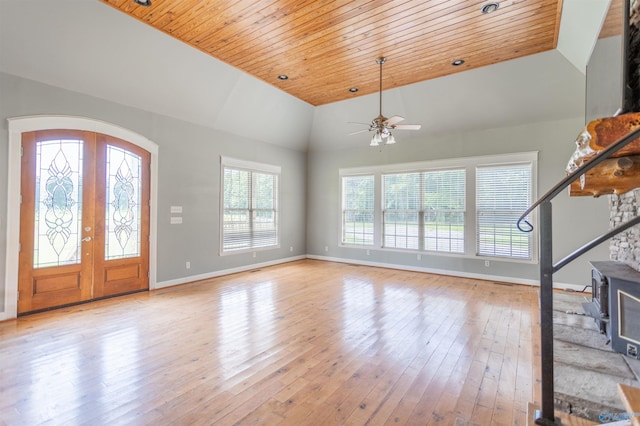 foyer entrance with wood ceiling, vaulted ceiling, light hardwood / wood-style floors, and french doors