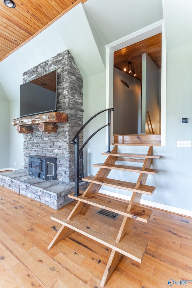 stairway with hardwood / wood-style floors and wood ceiling