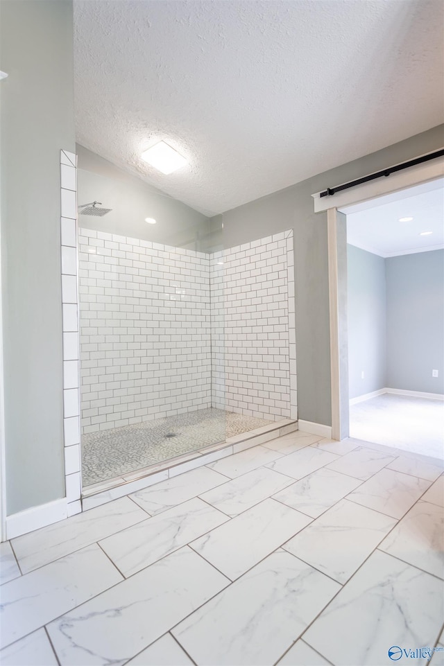 interior space featuring a tile shower and a textured ceiling