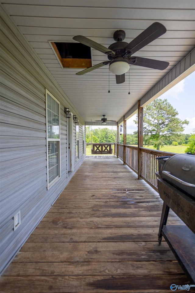 wooden deck featuring ceiling fan and covered porch