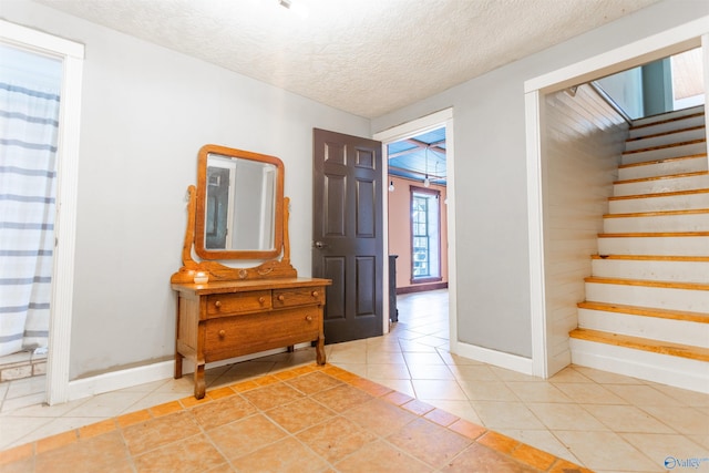 entrance foyer featuring light tile patterned flooring and a textured ceiling