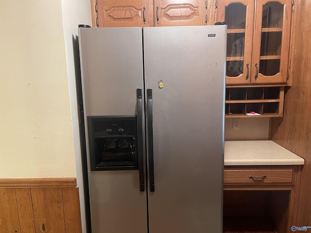 interior details with wood walls and stainless steel fridge with ice dispenser