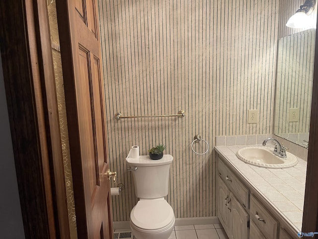 bathroom with tile patterned flooring, vanity, and toilet