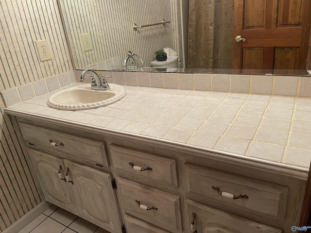 bathroom with tile patterned floors and vanity