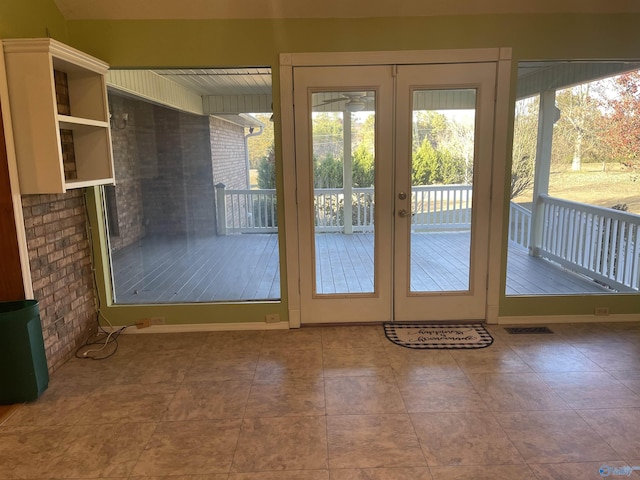 doorway to outside with tile patterned floors and french doors