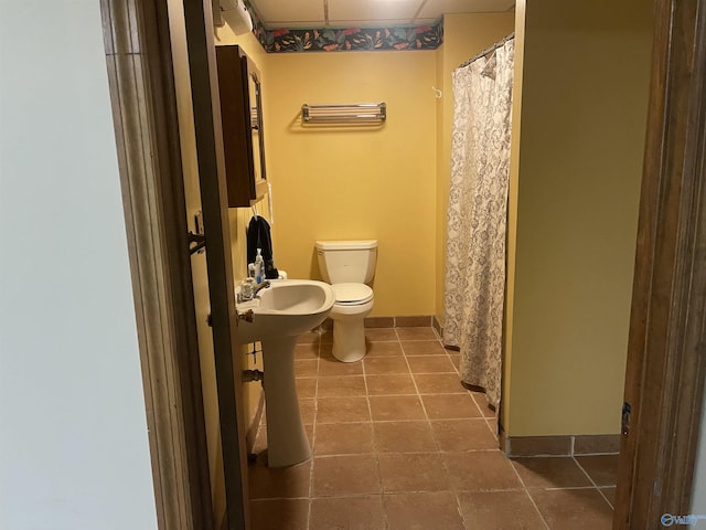 bathroom with tile patterned flooring and toilet