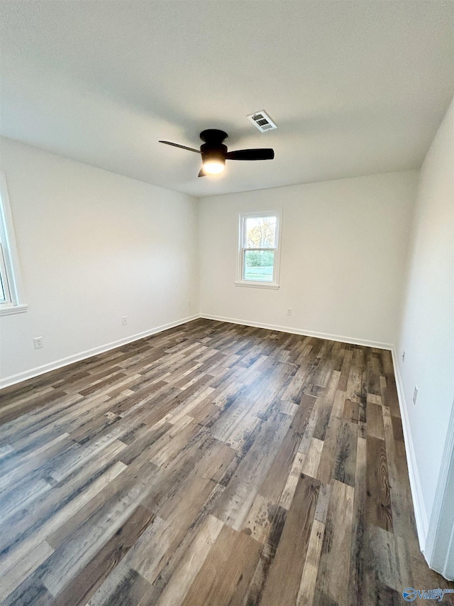 empty room featuring dark hardwood / wood-style flooring and ceiling fan