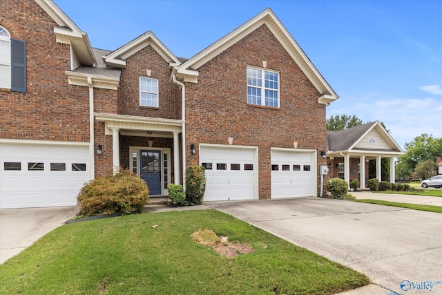 view of front of property with a garage and a front lawn