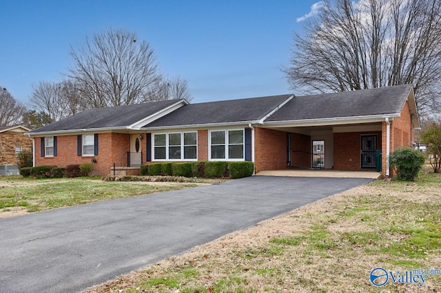 ranch-style house with a carport and a front lawn