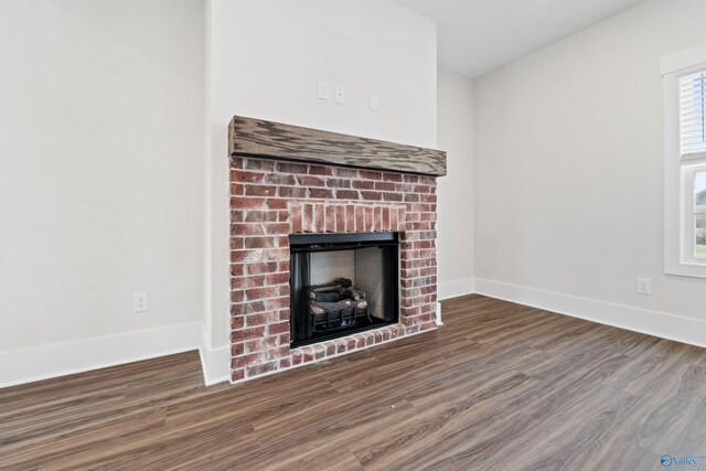 room details with a fireplace, baseboards, and wood finished floors