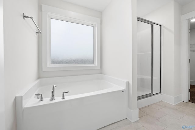 bathroom with a garden tub, tile patterned flooring, a spacious closet, and a shower stall