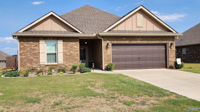 view of front of property featuring a front yard and a garage