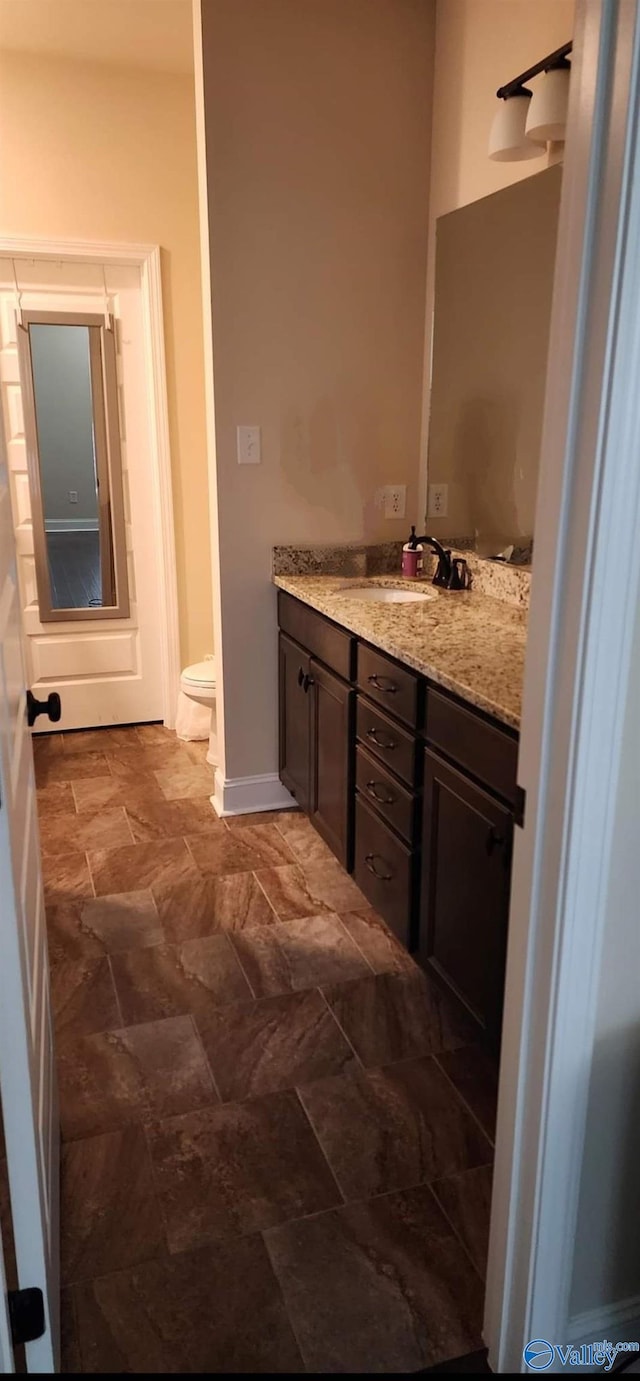 bathroom with vanity and toilet