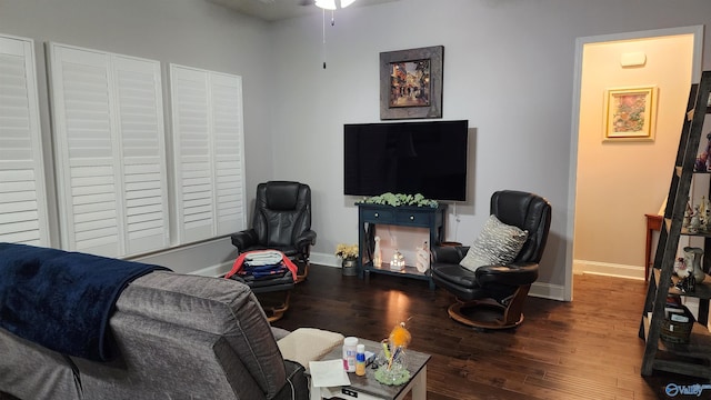 living room with ceiling fan and dark hardwood / wood-style flooring