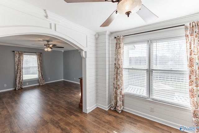 spare room featuring crown molding and dark wood-type flooring