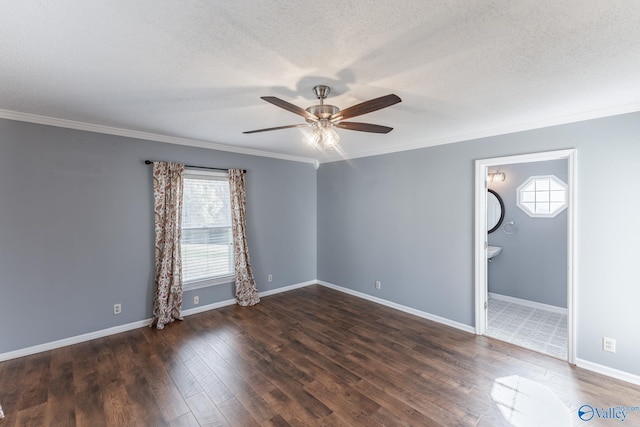 unfurnished room with a textured ceiling, ceiling fan, crown molding, and dark wood-type flooring