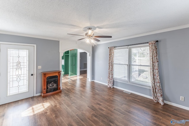 unfurnished living room with a textured ceiling, dark hardwood / wood-style floors, and ornamental molding