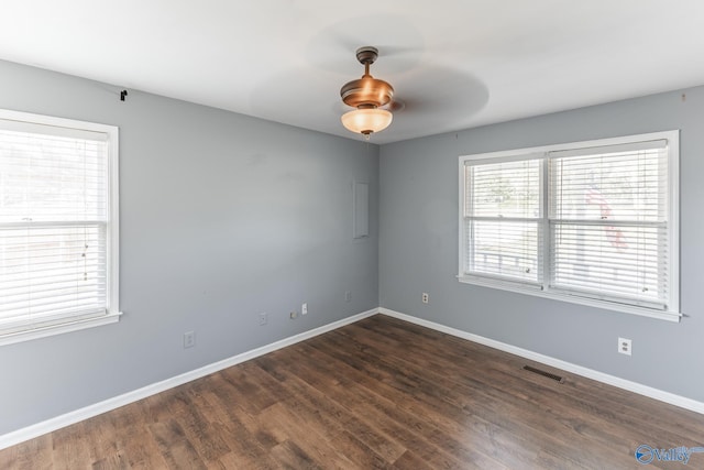 empty room featuring ceiling fan and dark wood-type flooring