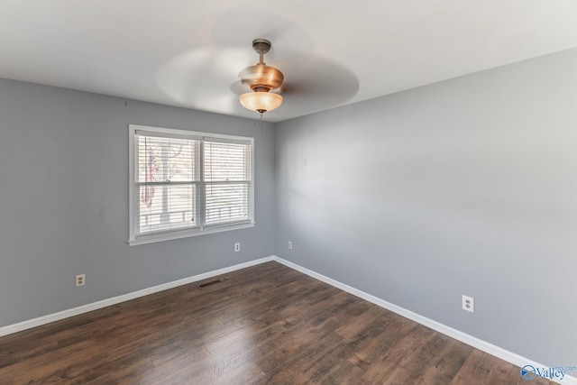 spare room with ceiling fan and dark hardwood / wood-style flooring