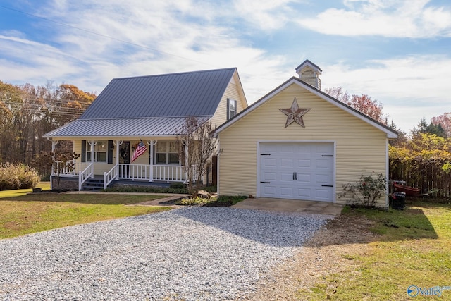 view of front of house featuring covered porch, a front yard, and a garage