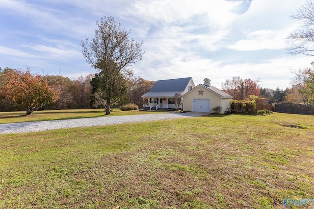 view of yard with covered porch and a garage