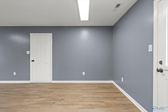 empty room with light hardwood / wood-style floors