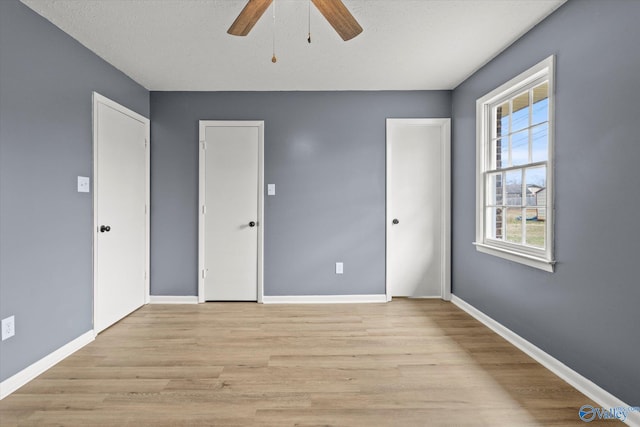 unfurnished bedroom with light wood-type flooring and ceiling fan