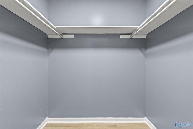 spacious closet featuring hardwood / wood-style floors